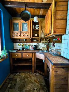 a kitchen with wooden cabinets and a counter top at Domek Stojkowo in Stojkowo