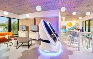 a room with a surfboard on a chair at Cloister at The Boca Raton in Boca Raton