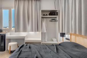 Ένα ή περισσότερα κρεβάτια σε δωμάτιο στο NOS Suites