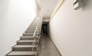 a staircase in a building with a stair railing at Obor Central Oasis --Self Check-in- Private Parking - 1min Metro Station in Bucharest