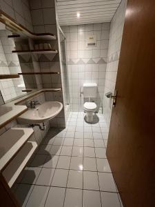 a bathroom with a toilet and a sink at Monteurzimmer Linz in Linz