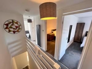 a hallway leading to a room with a mirror at The Quiet Sanctuary - 4 Bedroom in Swindon