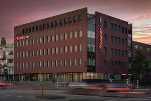 a large brick building with a sign on it at Hampton by Hilton Amsterdam Centre East in Amsterdam