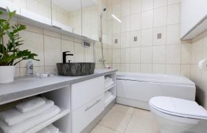 a white bathroom with a toilet and a sink at Obor Central Oasis --Self Check-in- Private Parking - 1min Metro Station in Bucharest