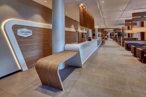 a lobby of a restaurant with a wooden bench at Hampton by Hilton Berlin City Centre Alexanderplatz in Berlin