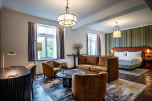 a hotel room with a bed and a living room at DoubleTree By Hilton Brussels City in Brussels
