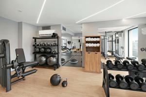 a gym with weights and equipment in a room at Hilton Garden Inn Bucharest Airport in Otopeni