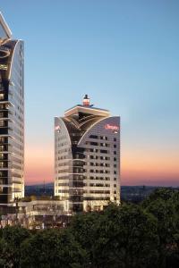 a tall building with a sign on top of it at Hampton By Hilton Bursa in Bursa