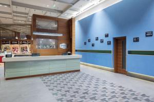 a lobby of a store with a blue wall at Hampton By Hilton Bursa in Bursa