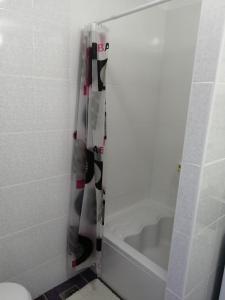 a shower curtain in a bathroom with a bath tub at Soba LIPA in Valpovo
