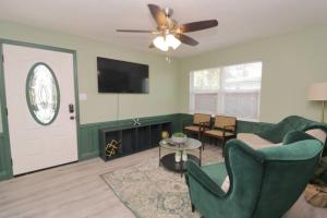 a living room with a couch and a ceiling fan at Stylish & Comfy Central Location in Orlando