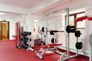 a fitness room with a gym with weights at MAX International Hotel in Râşnov