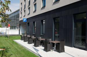 a row of tables and chairs outside of a building at Hampton by Hilton Frankfurt City Centre in Frankfurt/Main