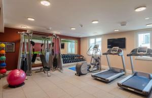 a gym with treadmills and exercise equipment in a room at Hampton by Hilton Frankfurt City Centre in Frankfurt