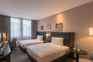 Cama ou camas em um quarto em Hilton Garden Inn Frankfurt City Centre