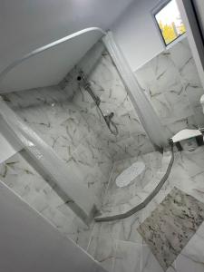 a bathroom with a glass table and a marble floor at La Olteanu in Brăila