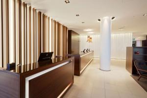 an office with a reception desk and a column at Hilton Reykjavik Nordica in Reykjavík