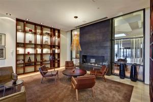 a living room with a table and chairs and a fireplace at Hilton Reykjavik Nordica in Reykjavík