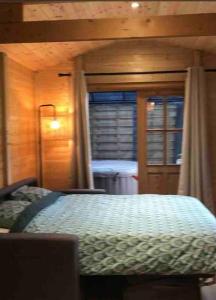 a bedroom with a bed and a window at Tiny House Close to Brussels South Charleroi Airport in Courcelles