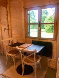 a wooden room with a table and chairs and a television at Tiny House Close to Brussels South Charleroi Airport in Courcelles