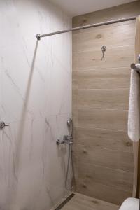 a shower with a glass door in a bathroom at Garden appartment in Ioannina