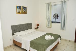 Postel nebo postele na pokoji v ubytování RECANTO PRAIA SUITES