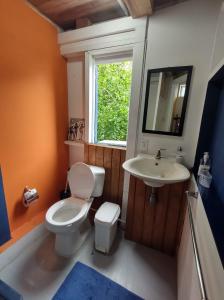 La salle de bains est pourvue de toilettes, d'un lavabo et d'une fenêtre. dans l'établissement Bellavista - Blue Lizard Studio, à Île de la Providence