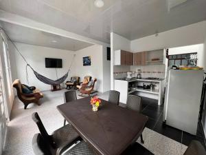 a living room with a table and a kitchen at Home Acacias in Acacías