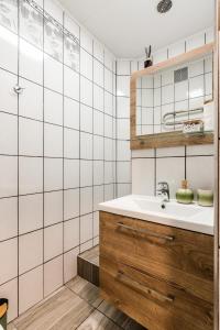 a bathroom with a sink and a mirror at Juozapaviciaus apartment in Kaunas