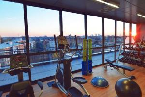 a gym with a view of the city from a building at Hilton Garden Inn Milan North in Milan