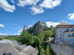 a view of a castle on top of a mountain at Le Peyragudes - Rue de la Grotte - 36m in Lourdes