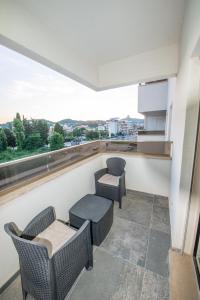a balcony with two chairs and a table and a counter at Apartment Lara in Ulcinj