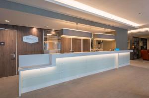 a large kitchen with a white counter in a room at Hampton By Hilton Munich City West in Munich