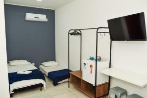מיטה או מיטות בחדר ב-RECANTO PRAIA SUITES