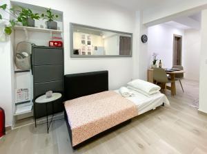 a small bedroom with a bed and a table at Garden appartment in Ioannina