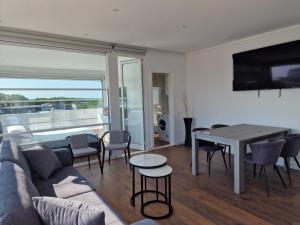 a living room with a couch and a table with chairs at Villa Pearl Adriatic Coast 4 in Golem