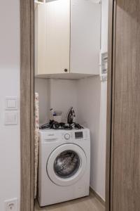 een wasmachine en droger in een kleine kamer bij Garden appartment in Ioannina