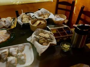 a table topped with baskets of bread and pastries at Agriturismo Santa Lucia in Tratalias