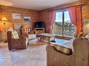 a living room filled with furniture and a large window at Lucada Les Carroz in Les Carroz d'Araches