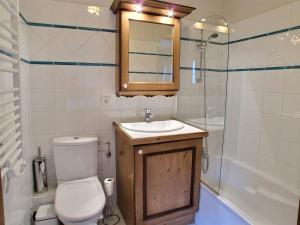 a bathroom with a toilet and a sink and a shower at Lucada Les Carroz in Les Carroz d'Araches +10 photos