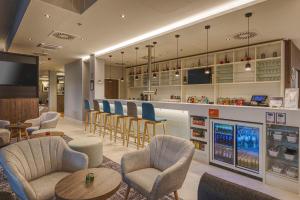 a restaurant with chairs and a bar with consoles at Hampton by Hilton Stuttgart City Centre in Stuttgart