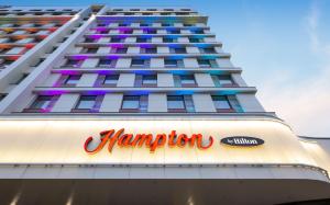 a tall building with a hongration sign on it at Hampton By Hilton Moscow Rogozhsky Val in Moscow