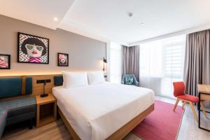 a hotel room with a bed and a desk at Hampton By Hilton Moscow Rogozhsky Val in Moscow