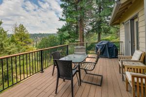 a wooden deck with a table and chairs on it at Resort-Style Klamath Falls Home, Golf Course View! in Klamath Falls