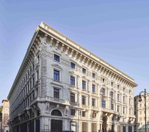 a large white building on the corner of a street at DoubleTree By Hilton Trieste in Trieste