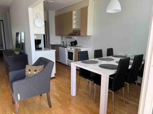 a kitchen and dining room with a table and chairs at Tornio Sauna appartment 2BR in Tornio