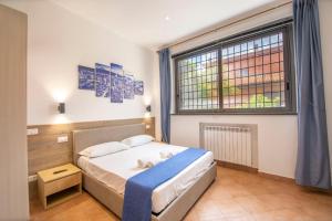 a bedroom with a bed and a large window at Anagnina Apartment in La Romanina