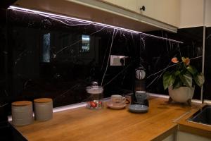 a kitchen with a counter with a coffee maker and a window at Garden appartment in Ioannina