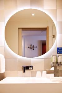 a bathroom with a mirror and a sink at Hampton By Hilton Vienna Messe in Vienna