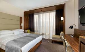 a hotel room with a large bed and a television at DoubleTree by Hilton Zagreb in Zagreb